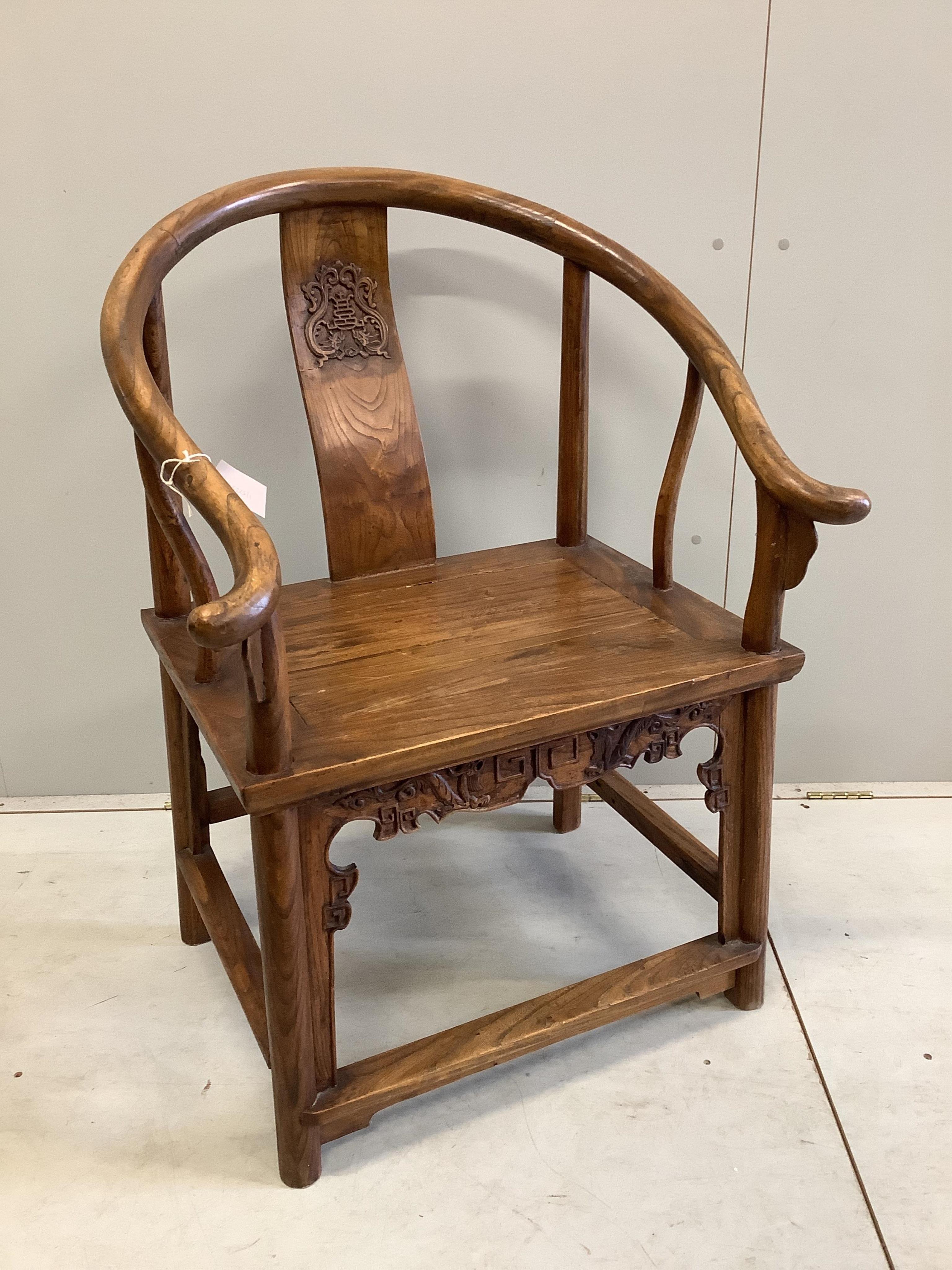 A Chinese carved elm elbow chair, width 71cm, depth 52cm, height 100cm. Condition - fair